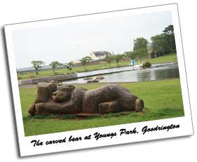 Looking toward the boating lake and duck pond at Youngs Park, Goodrington. View of a carved wooden bear, boating lake, duck pond and green at Youngs Park, Goodrington